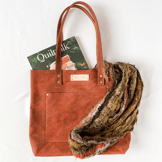 red leather tote bag on white background