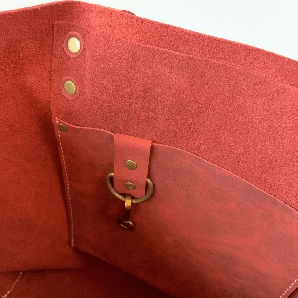 red leather tote bag on white background