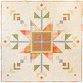 Lumi Quilt with snowflake pattern on a yellow polkadot background