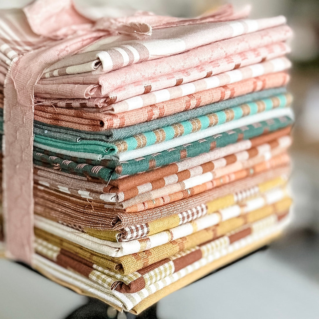 Remi Vail Studio curated fabric bundle for the Always Together Quilt Pattern in a pink, turquoise, rusty orange, and mustard yellow palette. All fabrics are wovens from Fableism Supply Co. and Robert Kaufman made of linen and cotton in various weights.