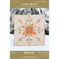 Lumi Quilt pattern by Remi Vail Studio with a geometric quilt design on a snowy background