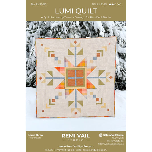 Lumi Quilt pattern by Remi Vail Studio with a geometric quilt design on a snowy background