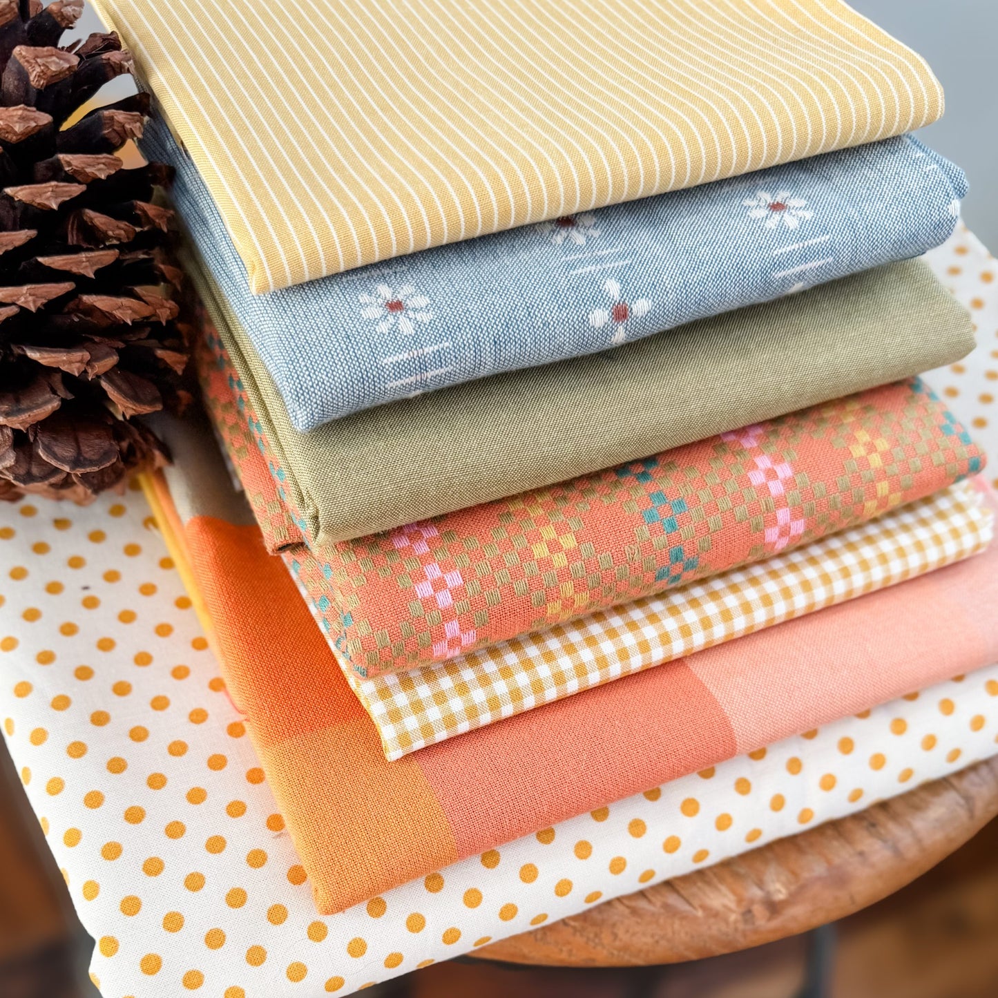 Collection of various yarn dyed woven fabrics for the quilt kit associated with Lumi Quilt Pattern by Remi Vail Studio.