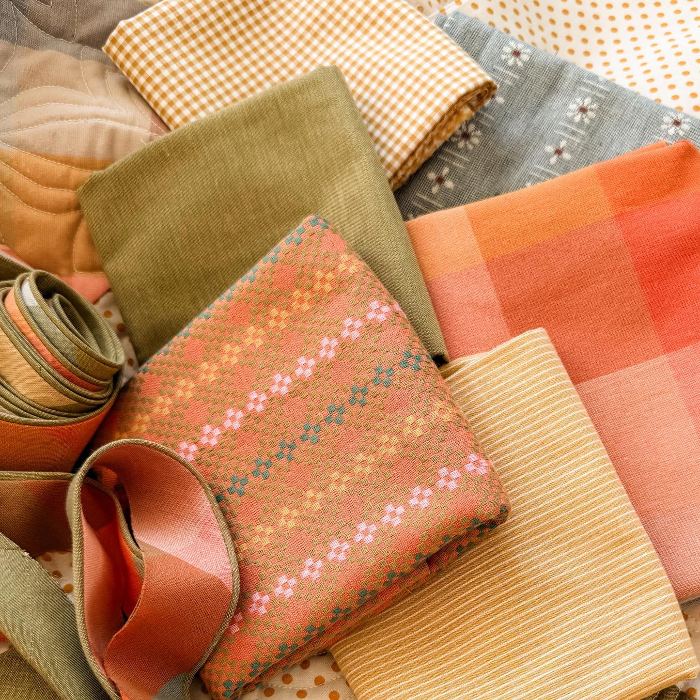 Collection of various yarn dyed woven fabrics for the quilt kit associated with Lumi Quilt Pattern by Remi Vail Studio.