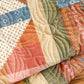 Close-up of a patchwork quilt with various colorful fabrics.