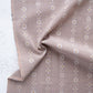 Brown fabric with floral pattern and 'Fableism' branding on a light background