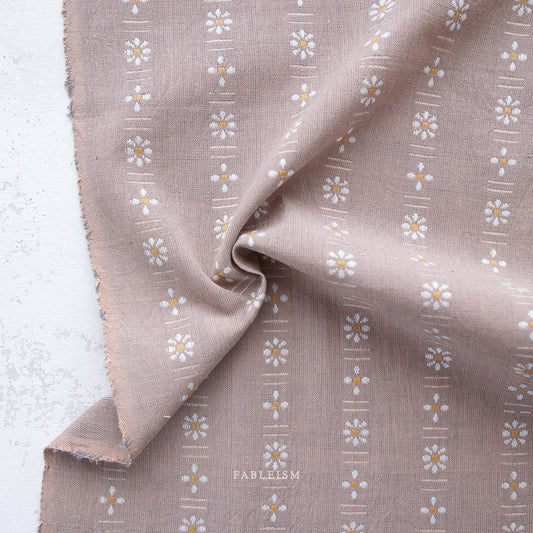 Brown fabric with floral pattern and 'Fableism' branding on a light background