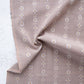 Brown fabric with floral pattern and 'Fableism' branding on a light background