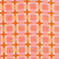 A close-up of a woven textile pattern featuring orange plaid lines with orange crosses over a pink and white background.