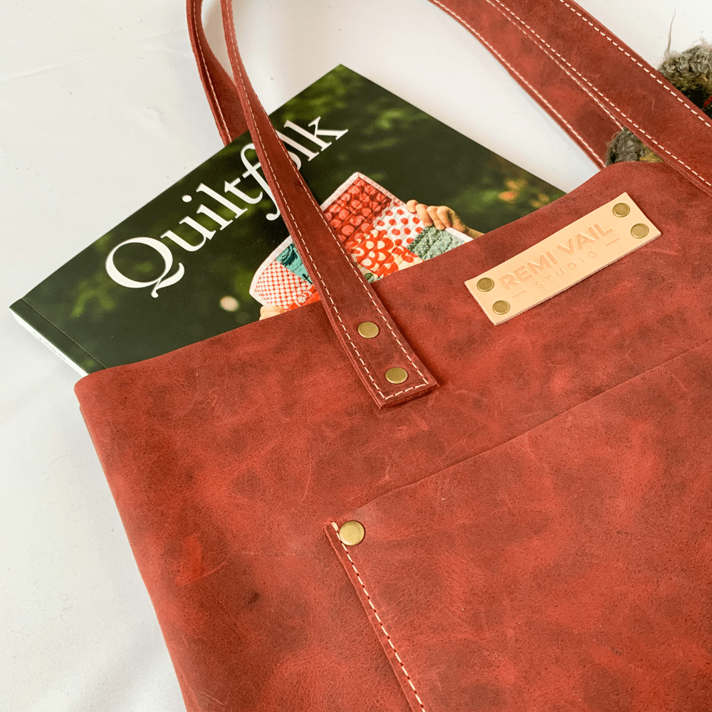 red leather tote bag on white background