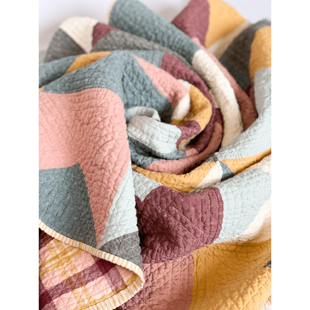 Love Notes Quilt swirled on a white background.