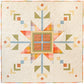 Lumi Quilt with snowflake pattern on a yellow polkadot background