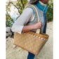 Woman holding the Maggie Poppins Tote with a blonde dog in the background.