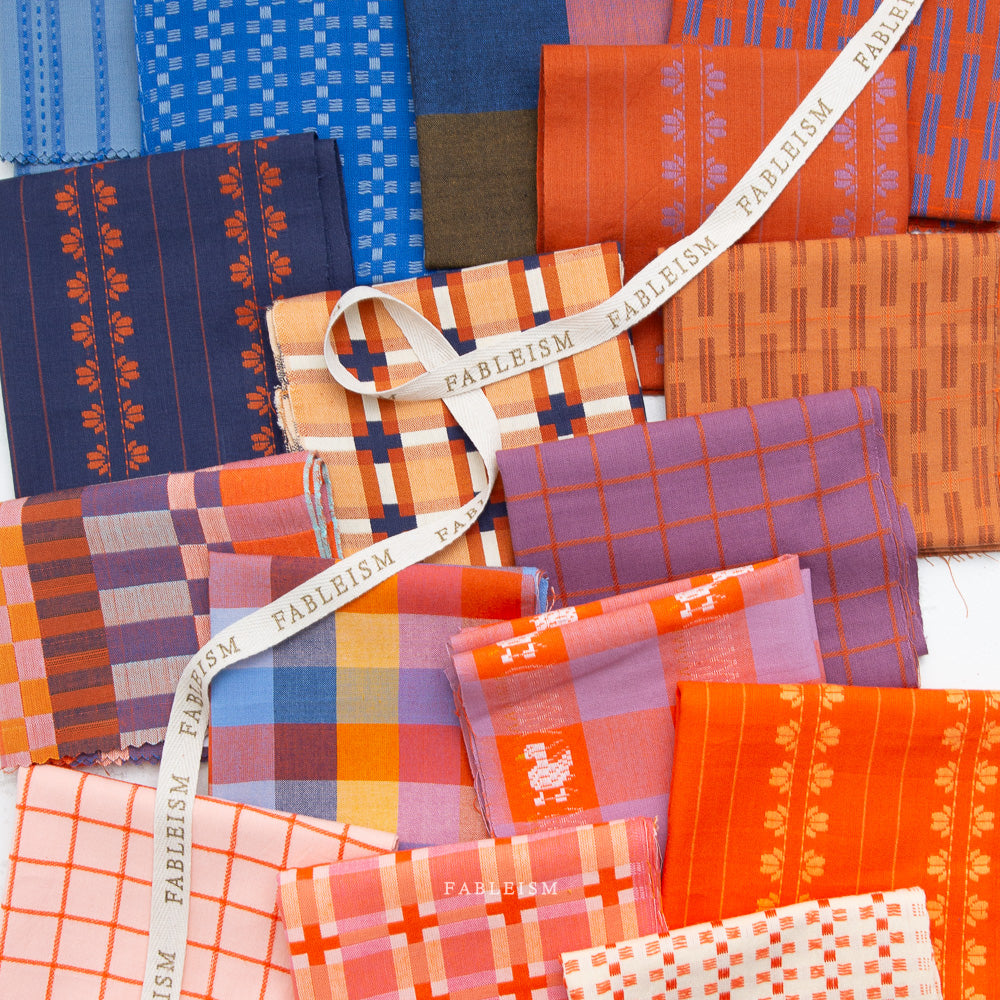 Collection of colorful fabric swatches with 'Fableism' branding.