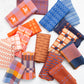 Collection of patterned fabric swatches in various colors on a white background