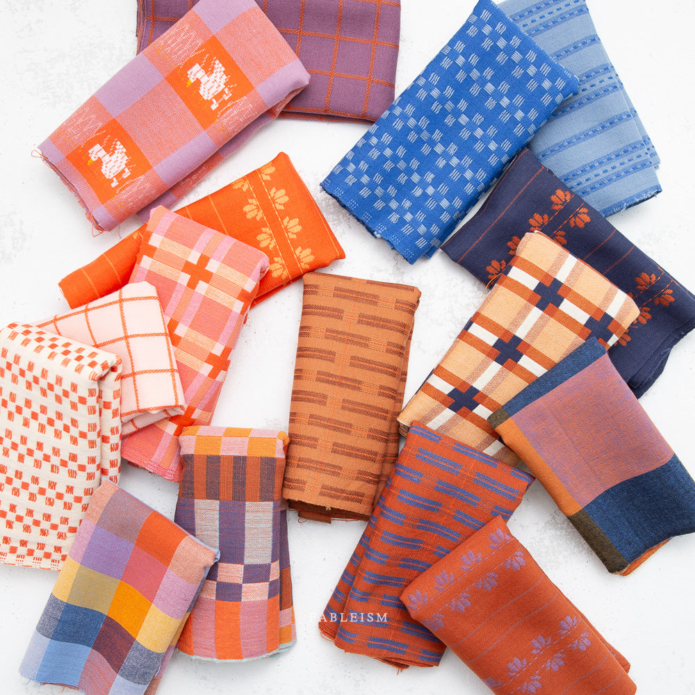 Collection of patterned fabric swatches in various colors on a white background